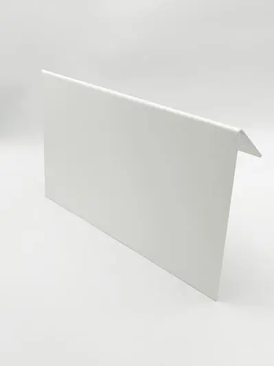 A white metal flashing piece with one bent edge, near branded warehouse signs.